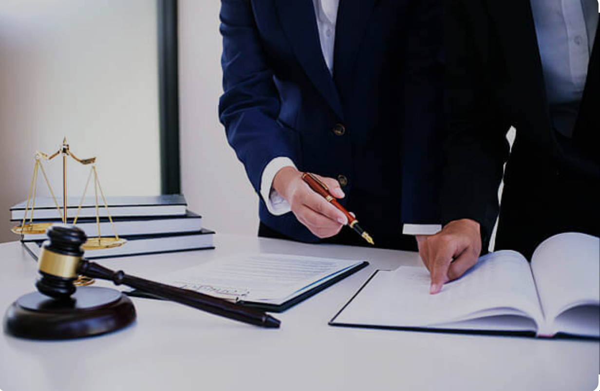 'A judge holding a pen over a document
AI-generated content may be incorrect.'