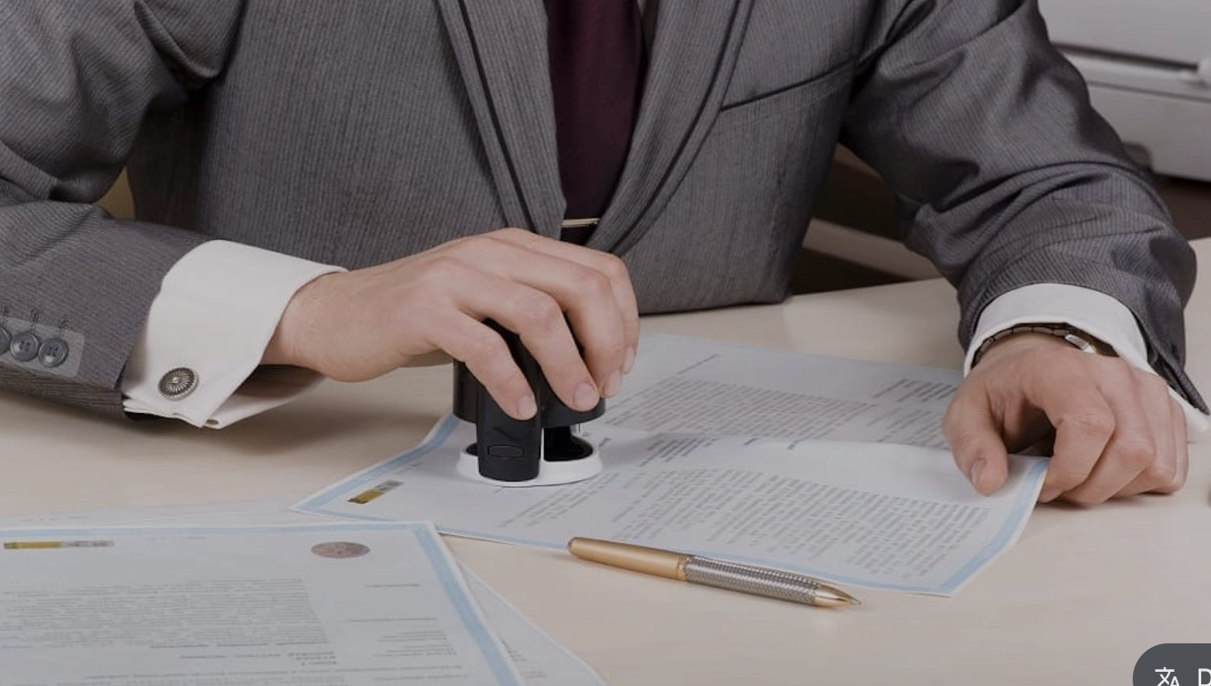 'A person stamping a document
AI-generated content may be incorrect.'